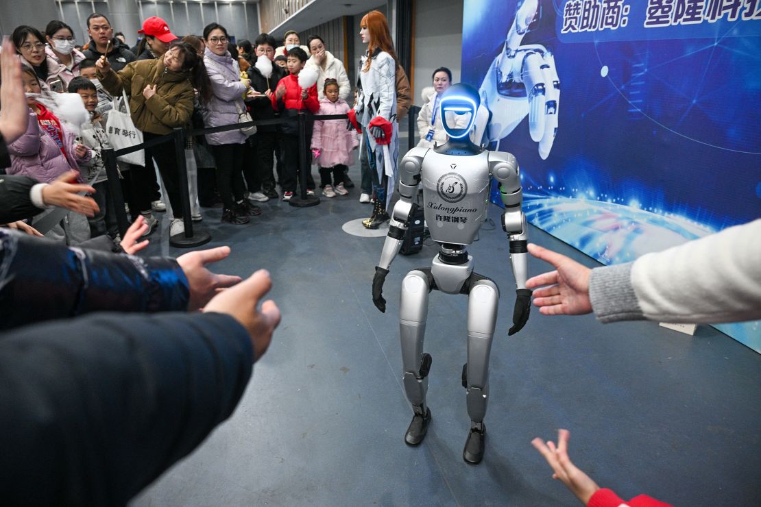 A humanoid robot entertains the crowd at a robotics exhibition in eastern China
