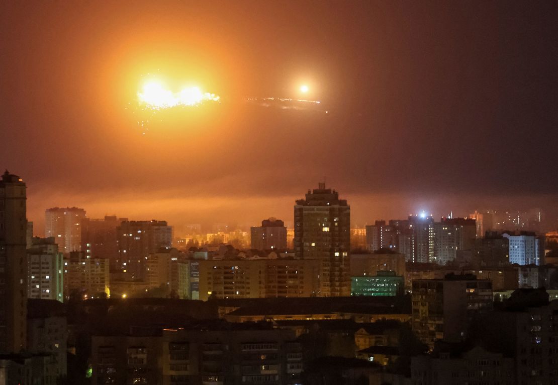 A ballistic missile explodes in the sky over Kyiv during a Russian drone strike.