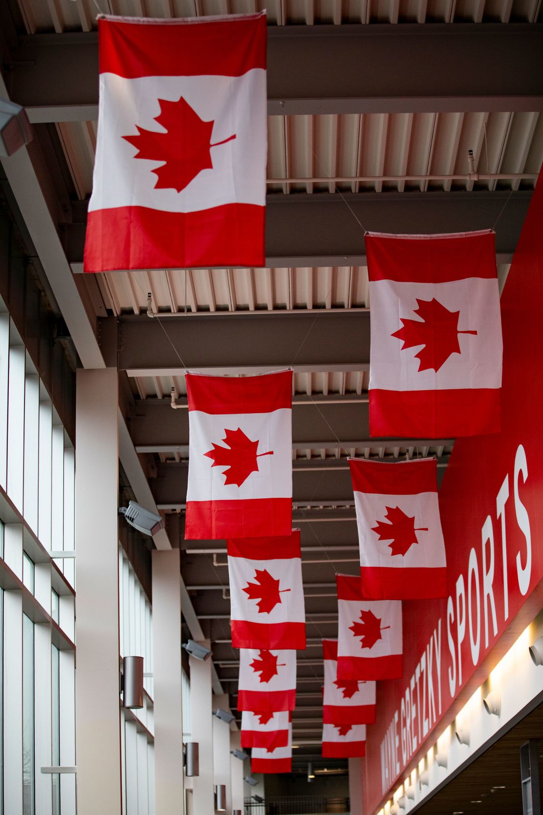 Rows of Canadian flags hang from the ceiling inside the Wayne Gretzky Sports Centre.