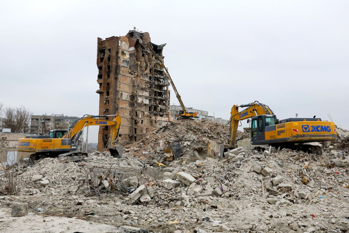 Excavators demolish multi-storey apartment blocks in Russian-occupied Mariupol on March 16, 2023.