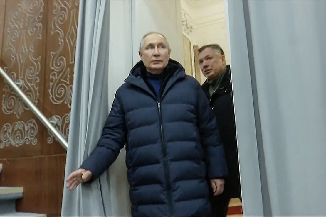 This screenshot from Russian TV shows Russian President Vladimir Putin with Russian Deputy Prime Minister Marat Khusnullin on a visit to Mariupol on March 19, 2023.